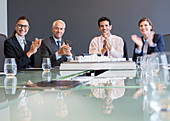 Business people applauding in meeting