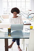 Woman using laptop at desk