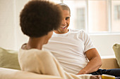 Couple relaxing together on sofa