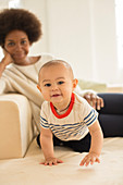 Mother and baby boy relaxing on sofa