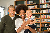 Family smiling together in living room