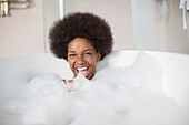 Woman laughing in bubble bath