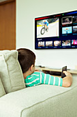 Boy watching television in living room