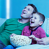 Father and son watching television