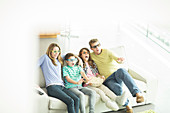 Family watching 3D television