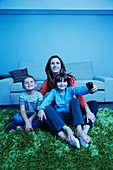 Mother and children watching television