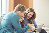 Family using laptop in living room