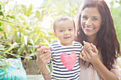 Mother holding daughter outdoors