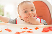 Baby boy eating gelatine