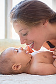 Mother playing with baby boy on table