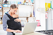 Mother with baby boy using laptop