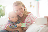 Mother taking self-portrait with baby