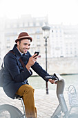 Businessman using cell phone in Paris