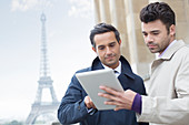 Businessmen using tablet in Paris