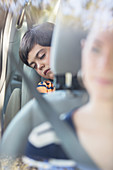 Boy sleeping in back seat of car