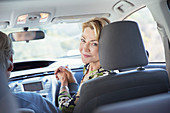 Portrait of smiling woman inside car