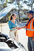 Woman shaking hands with mechanic