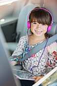 Happy girl with headphones using tablet