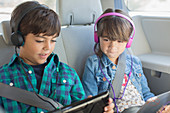 Brother and sister using tablets