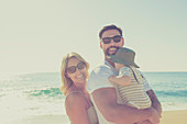 Portrait of happy family on sunny beach