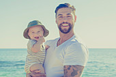 Portrait of father and baby son smiling