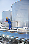 Worker using cell phone on platform