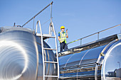 Worker using walkie-talkie on platform