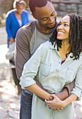 Happy couple hugging outdoors