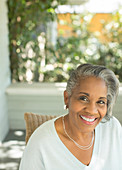 Portrait of smiling senior woman on porch
