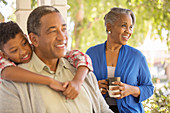 Happy grandparents and grandson on porch