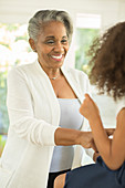 Grandmother smiling at granddaughter