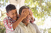 Grandson surprising grandfather on porch