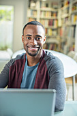 Portrait of smiling man at laptop