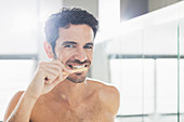 Portrait of man brushing teeth