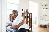 Senior couple hugging in living room