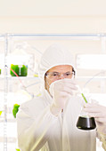 Scientist with beaker in laboratory