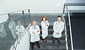 Portrait of confident doctors on stairs