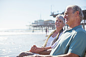 Senior couple relaxing on sunny beach