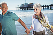 Enthusiastic senior couple running