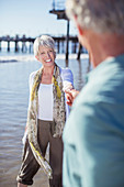 Senior couple holding hands on beach