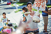 Woman paying for lamp at yard sale