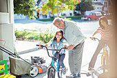 Grandfather and granddaughter on bike