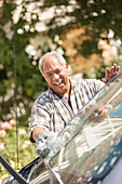Happy man washing car