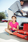 Father and daughter fixing car engine