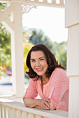 Woman leaning on porch railing