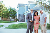 Portrait of smiling family in driveway