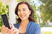 Woman text messaging with cell phone