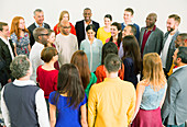 Diverse crowd meeting in circle