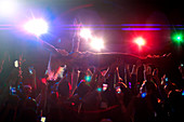Woman crowd surfing at concert
