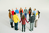 Business people holding hands in circle